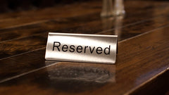 Winco Reserved Table Signs in a banquet setting
