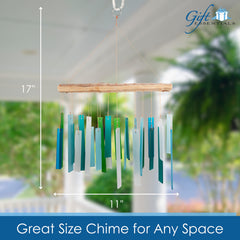 Wind chime hanging in a sunny window casting colourful light