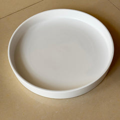 Yukfona plant saucer with potted plant on a table