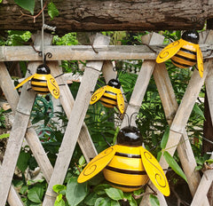 Yungeln Metal Bees placed in a garden setting