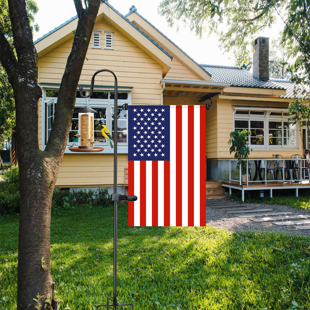 Akeydeco Garden Flag Stand in garden setting with seasonal flags