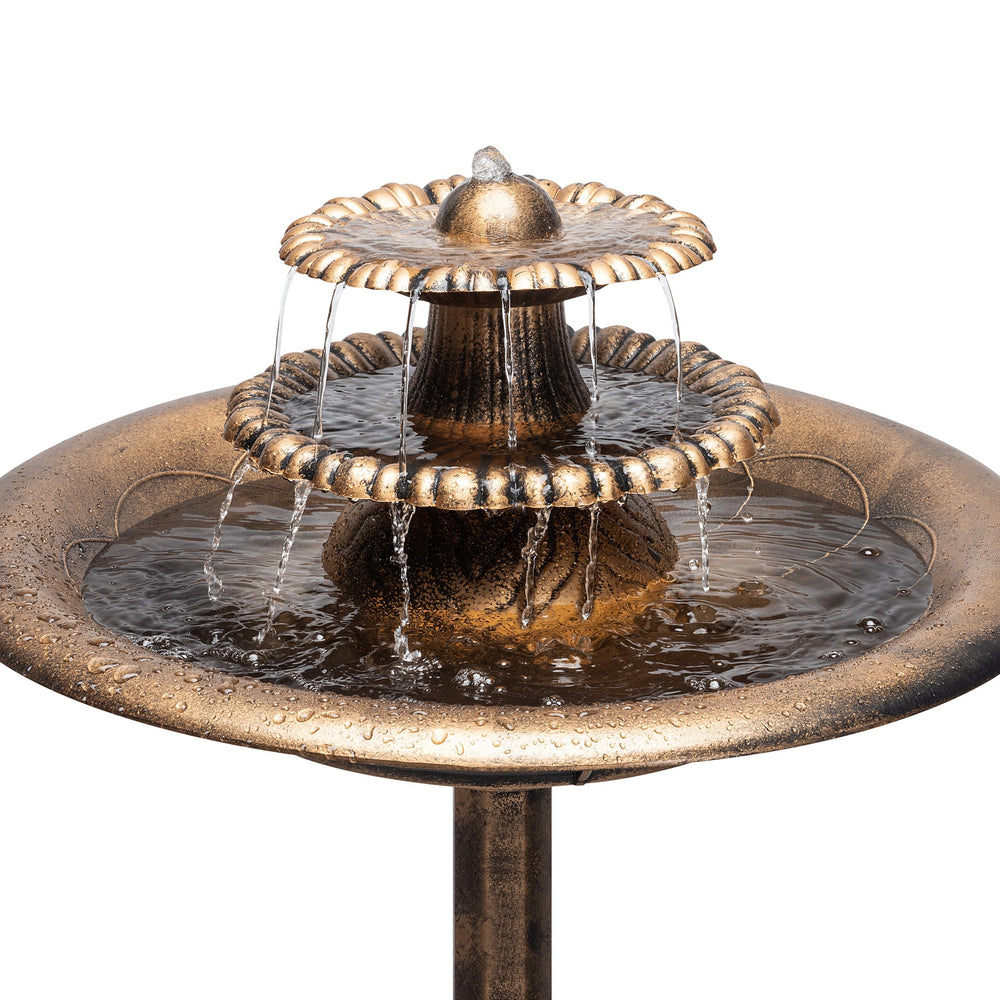 Alpine water fountain with vibrant garden background