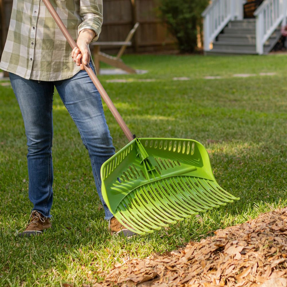 AMES rake in a garden setting with leaves piled