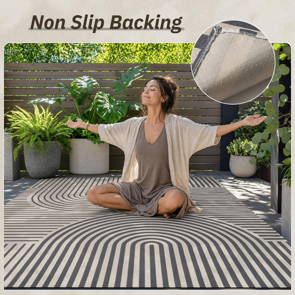 AMOAMI Outdoor Rug 5x8 ft in front of a door, welcoming look