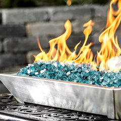 Aqua Blue fire glass rocks in a fire pit, glowing