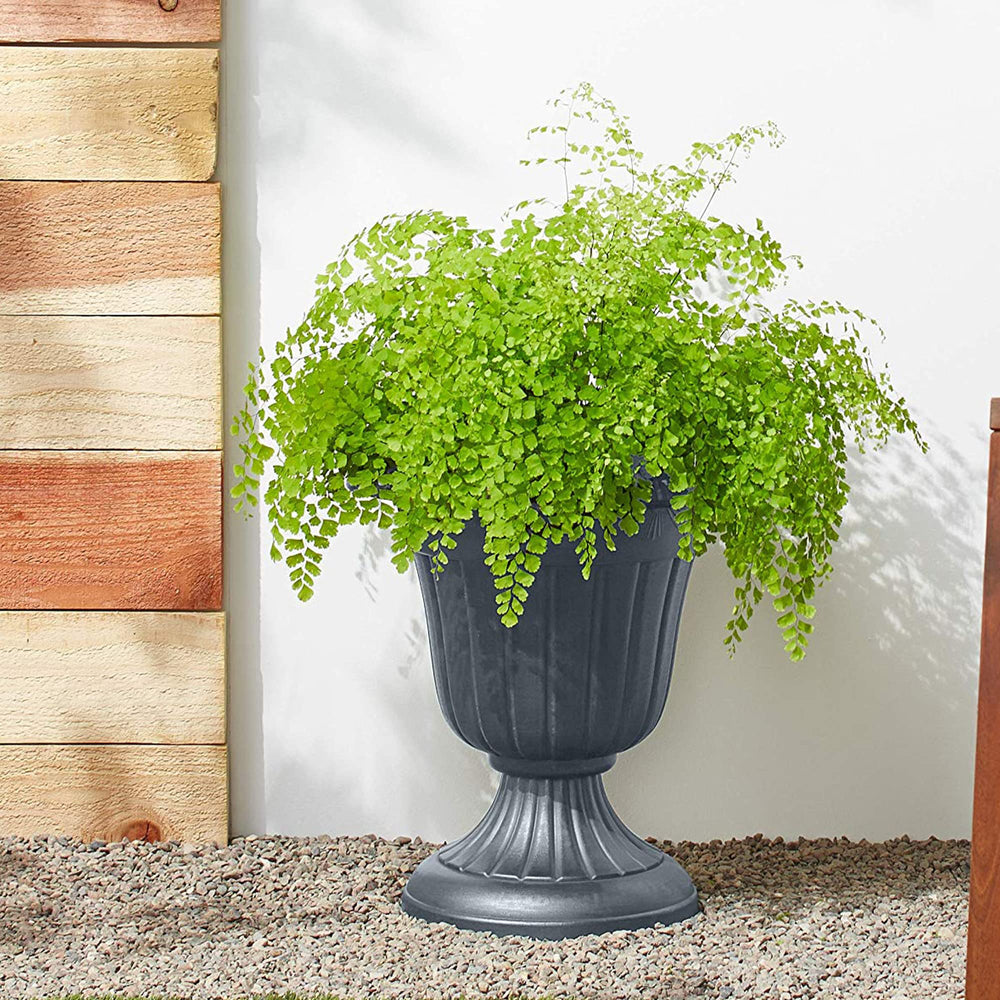 Arcadia Urn Planter displayed with flowers on a porch