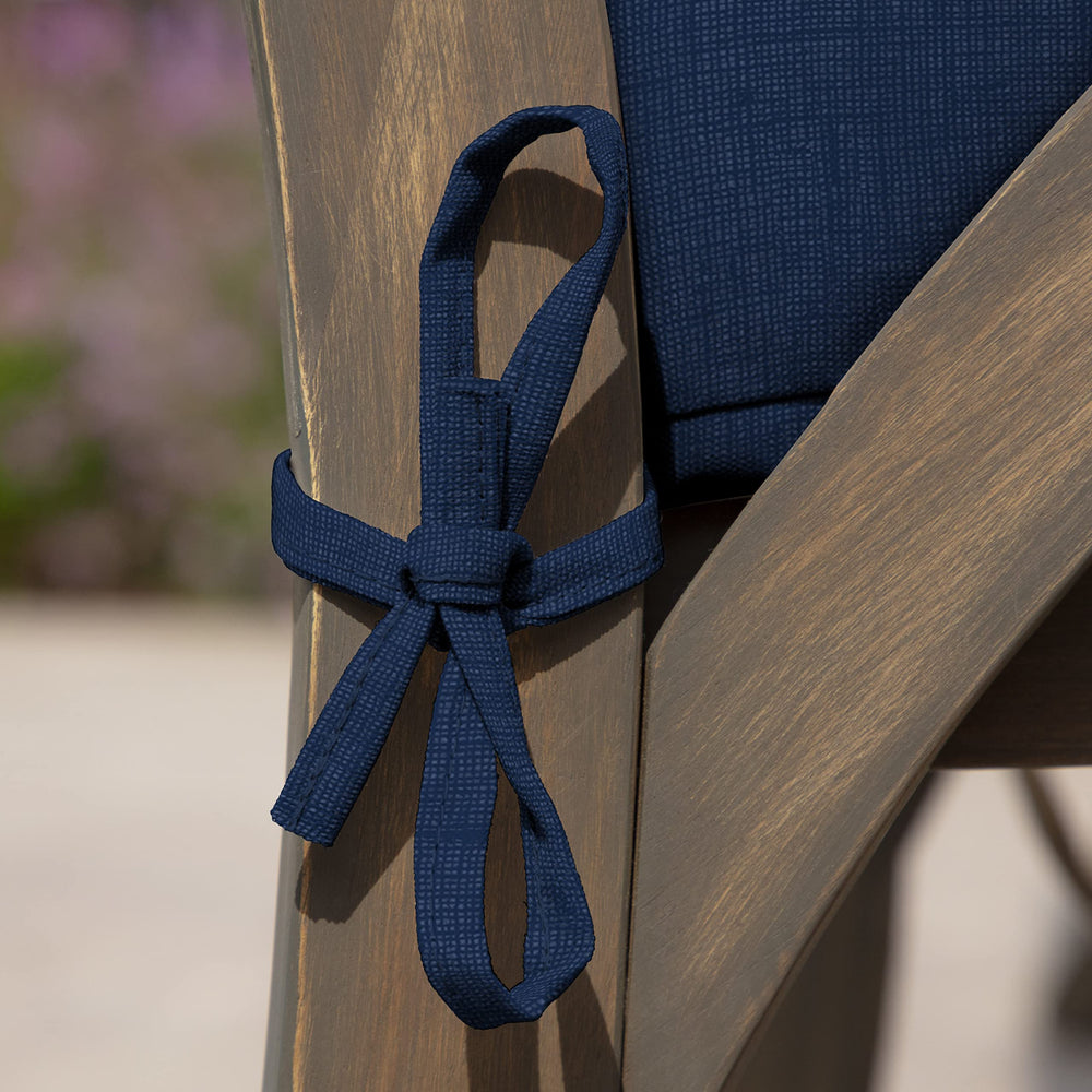 Arden Selections Outdoor Dining Chair Cushion Set in use at a garden table