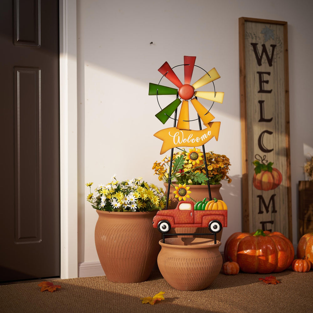 Assembled wind spinner next to flowers in a sunny garden