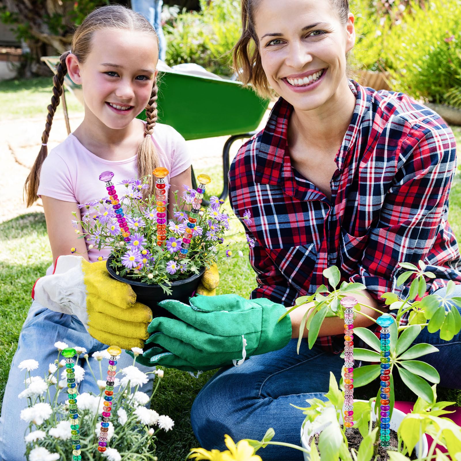 Assorted colourful garden stakes in a vibrant garden