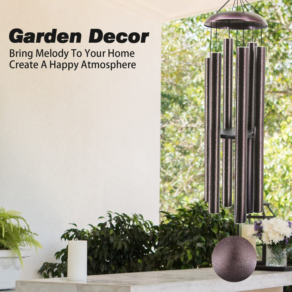 ASTARIN wind chimes with sunlight reflecting off the bronze finish