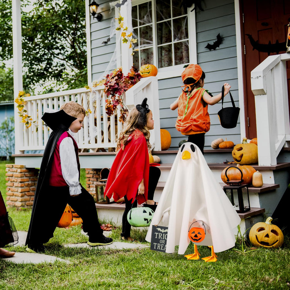 Aymolas Halloween Goose Costume in a festive outdoor display with skeletons and pumpkins