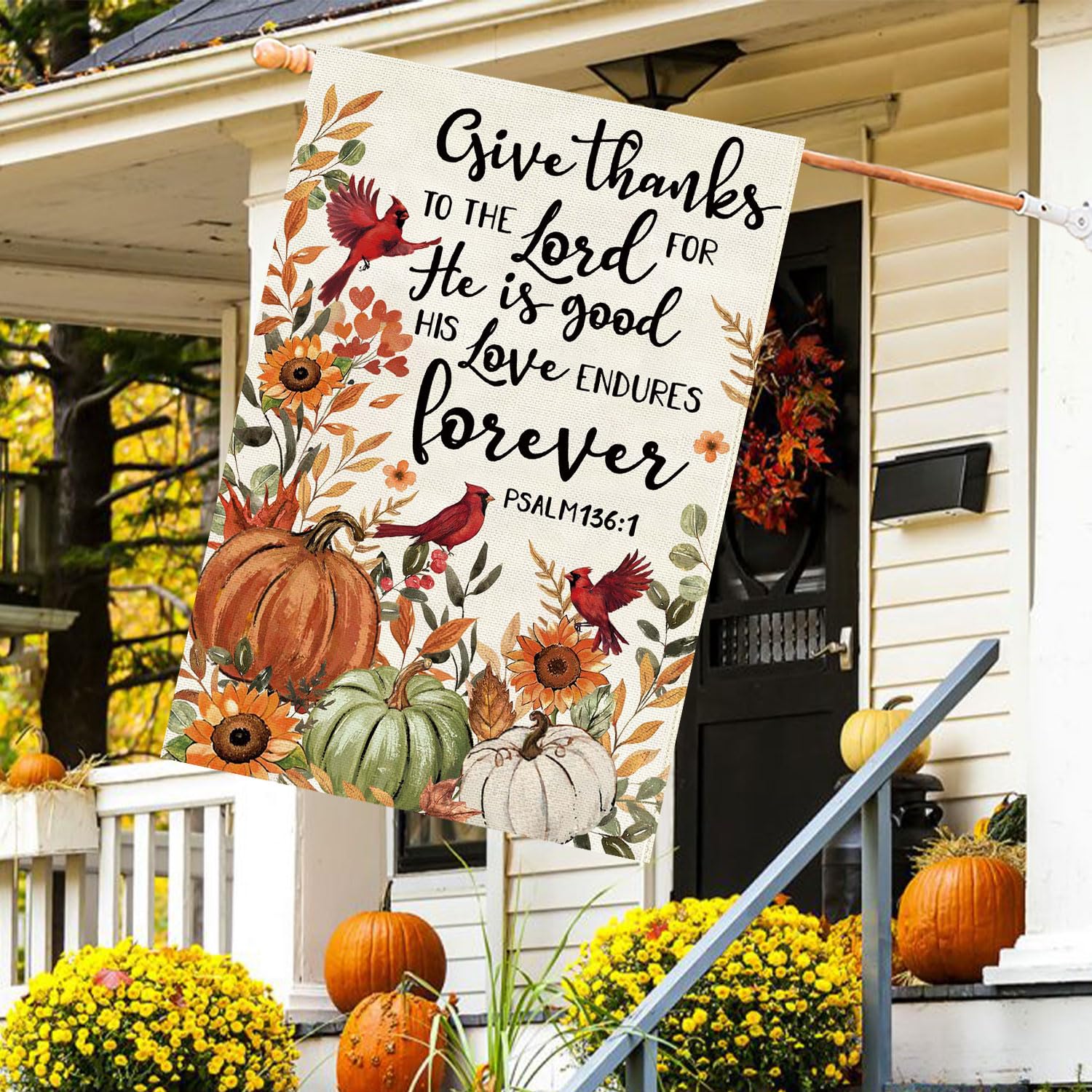Baccessor Fall House Flag hanging in a garden setting