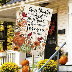 Baccessor Fall House Flag hanging in a garden setting