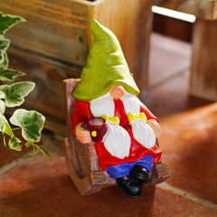 Back view of the coffee-drinking gnome statue