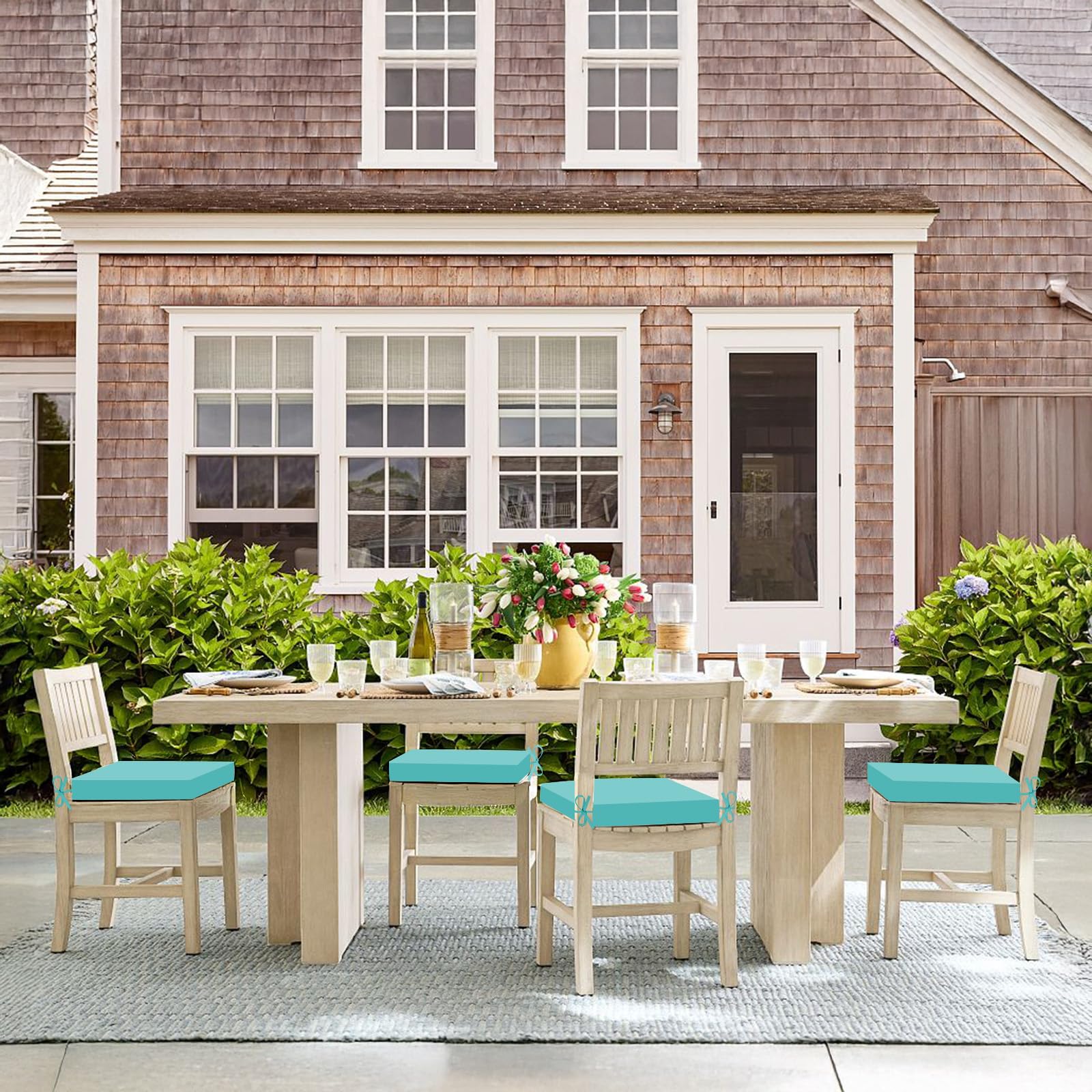 Basic Beyond Outdoor Chair Cushions set on a sunny patio