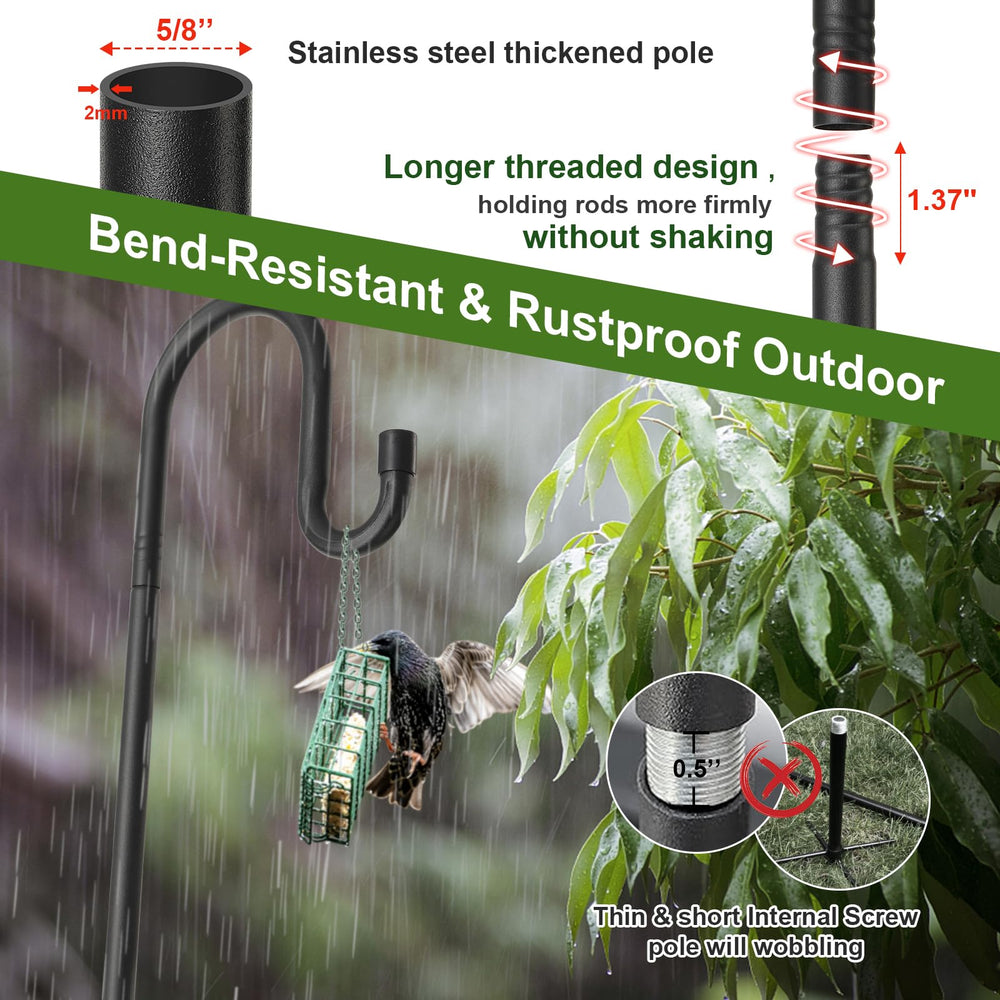Bird feeder pole set up in a garden with flowers