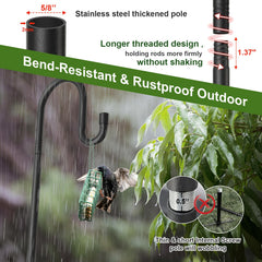 Bird feeder pole set up in a garden with flowers