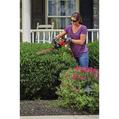 BLACK+DECKER hedge trimmer plugged in for use