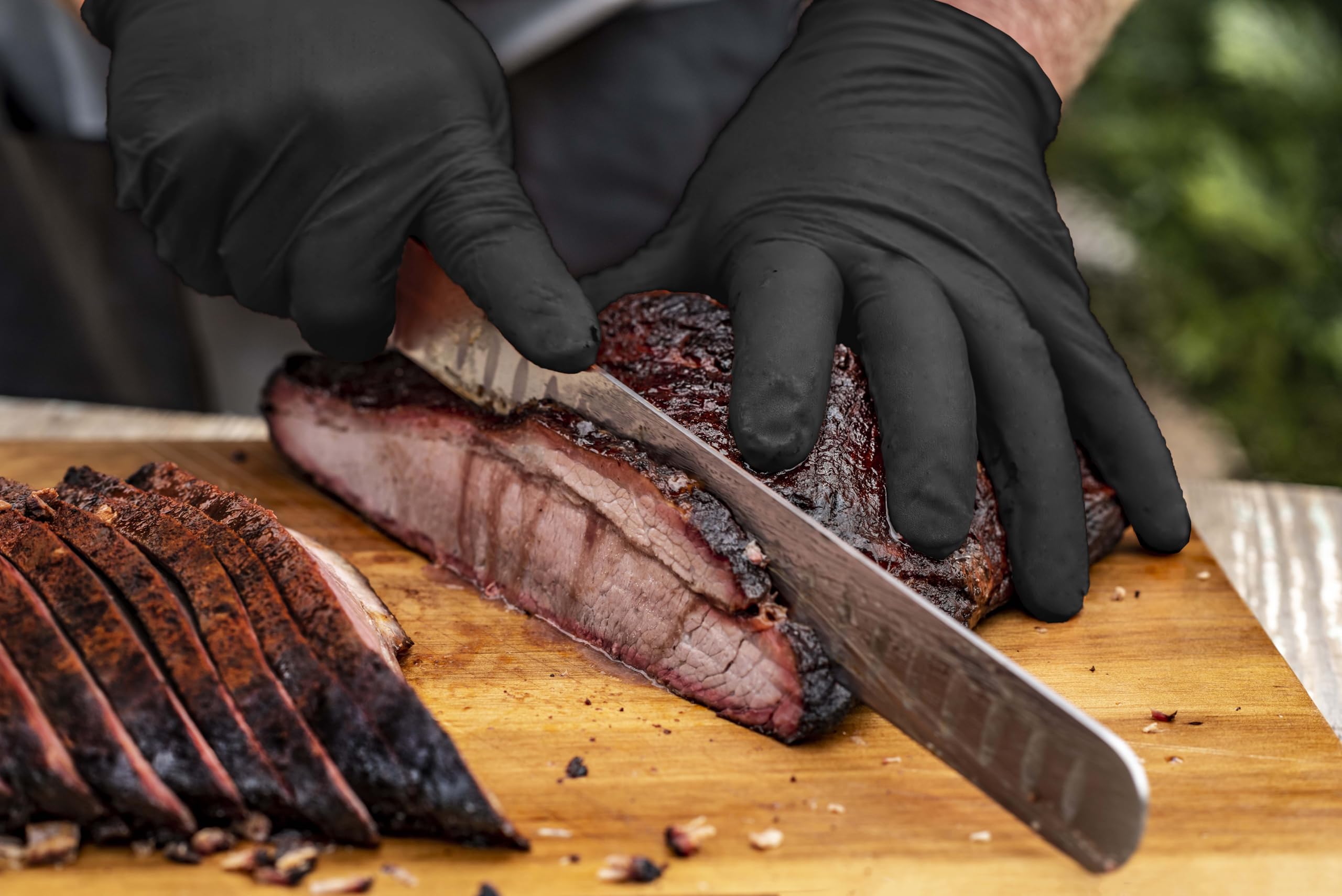 Black nitrile gloves from Oklahoma Joe's in action during food prep