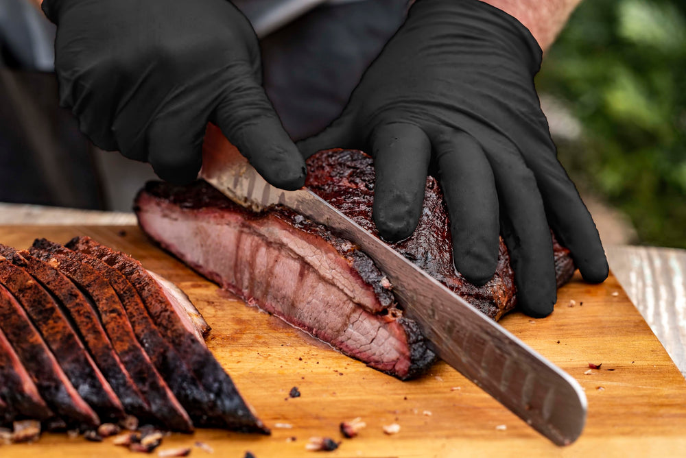 Black nitrile gloves from Oklahoma Joe's in action during food prep