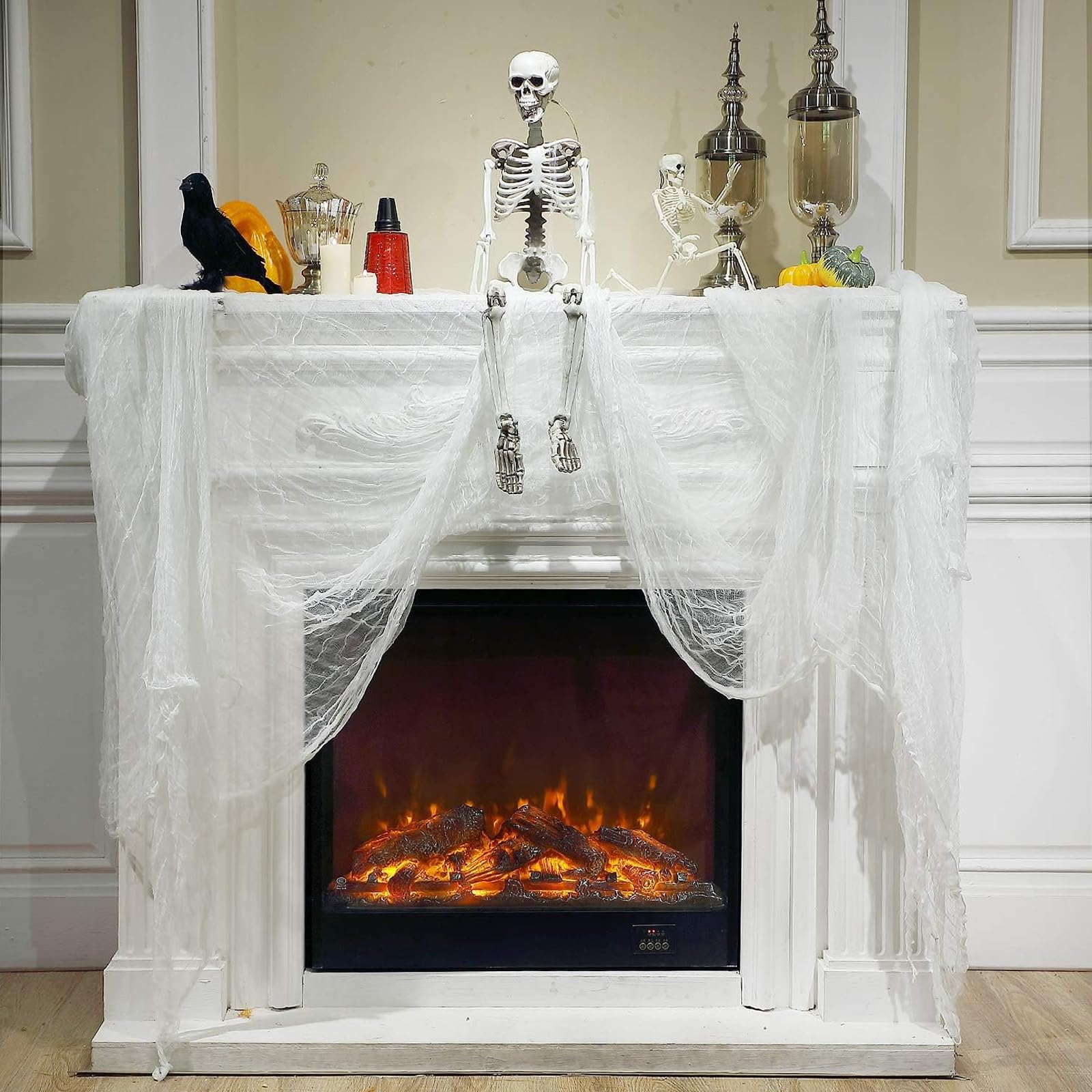 Boao cheesecloth draped across a mantel for Halloween decor