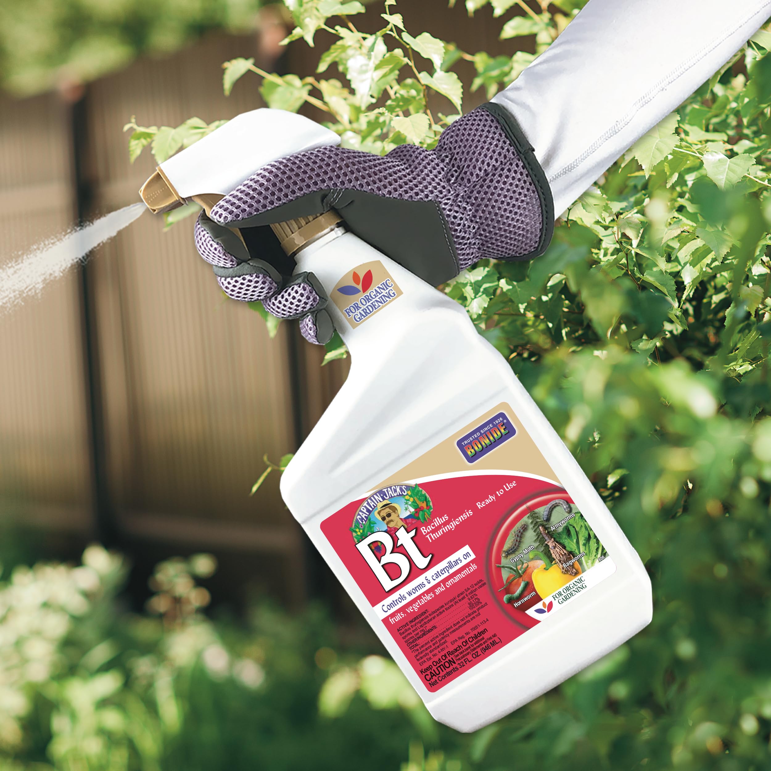 Bonide Captain Jack's BT spray bottle with plants in the background