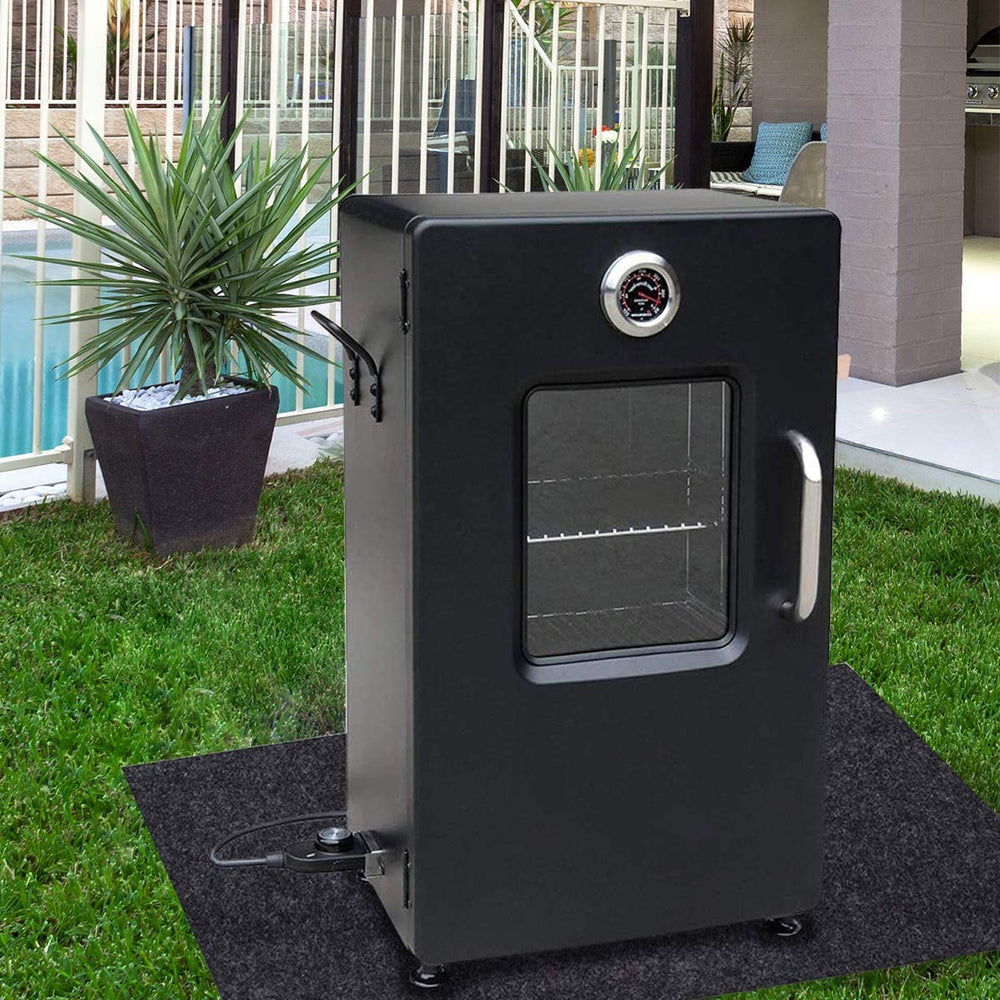 Brinman Under Grill Mat laid under a charcoal grill