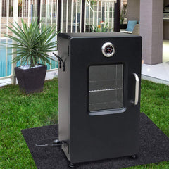 Brinman Under Grill Mat laid under a charcoal grill