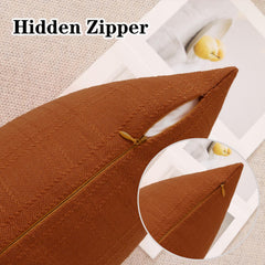 Burnt orange pillow cover by K KEVIN TEXTILE displayed in a garden setting