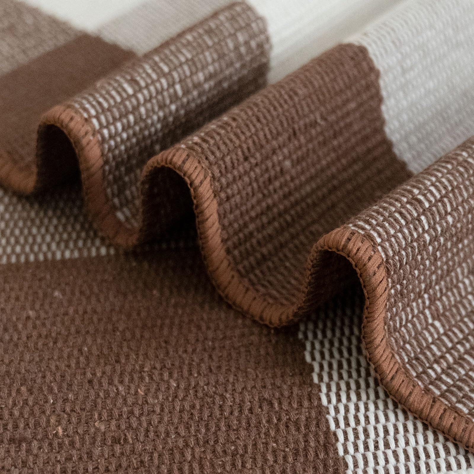 CAINANEL Buffalo Check Outdoor Rug rolled up for storage