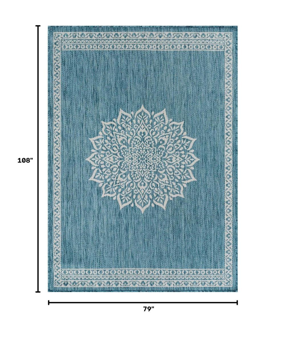 CAMILSON Outdoor Rug 6x9 Medallion Aqua in a garden setting