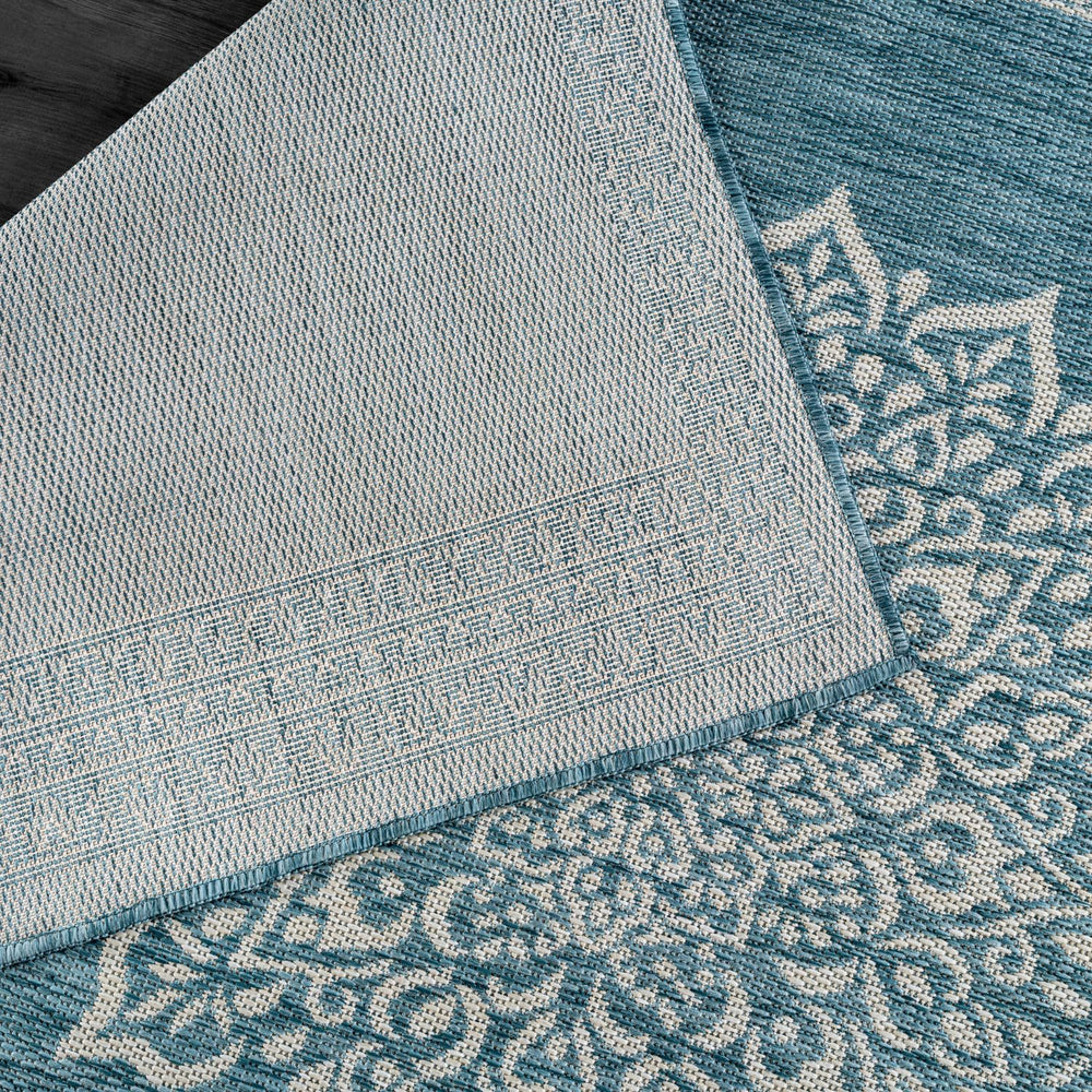 CAMILSON Outdoor Rug 6x9 Medallion Aqua in a living room