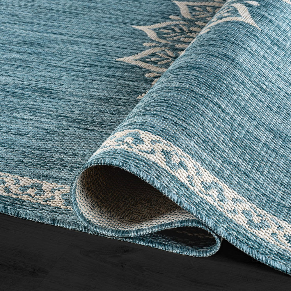 CAMILSON Outdoor Rug 6x9 Medallion Aqua on a patio