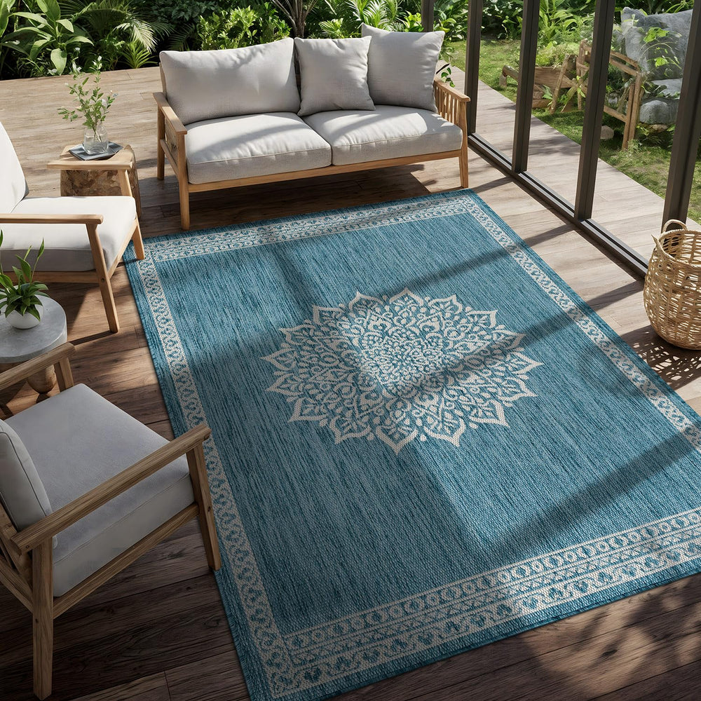 CAMILSON Outdoor Rug 6x9 Medallion Aqua rolled up for storage