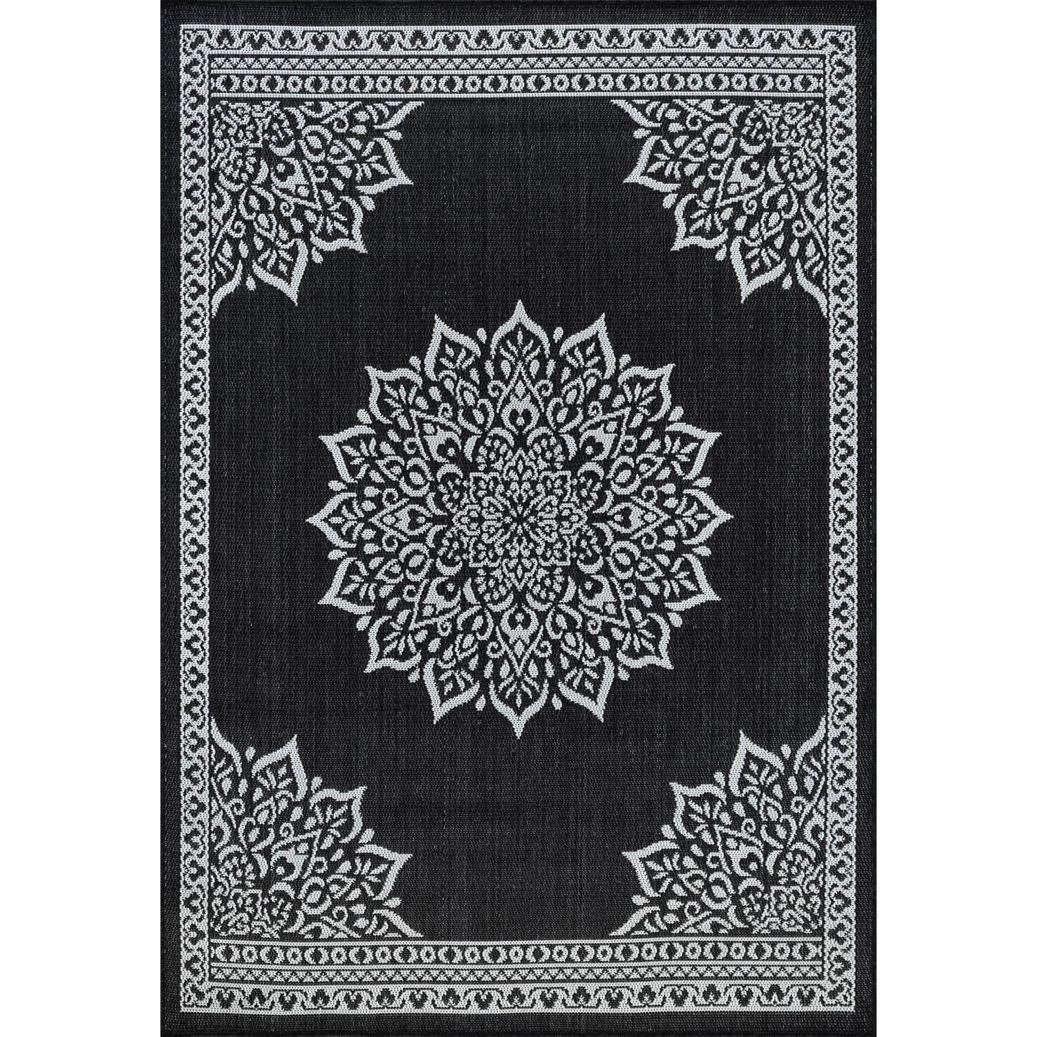 CAMILSON Outdoor Rug 6x9 Medallion Black in a garden setting