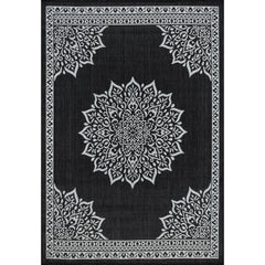 CAMILSON Outdoor Rug 6x9 Medallion Black in a garden setting