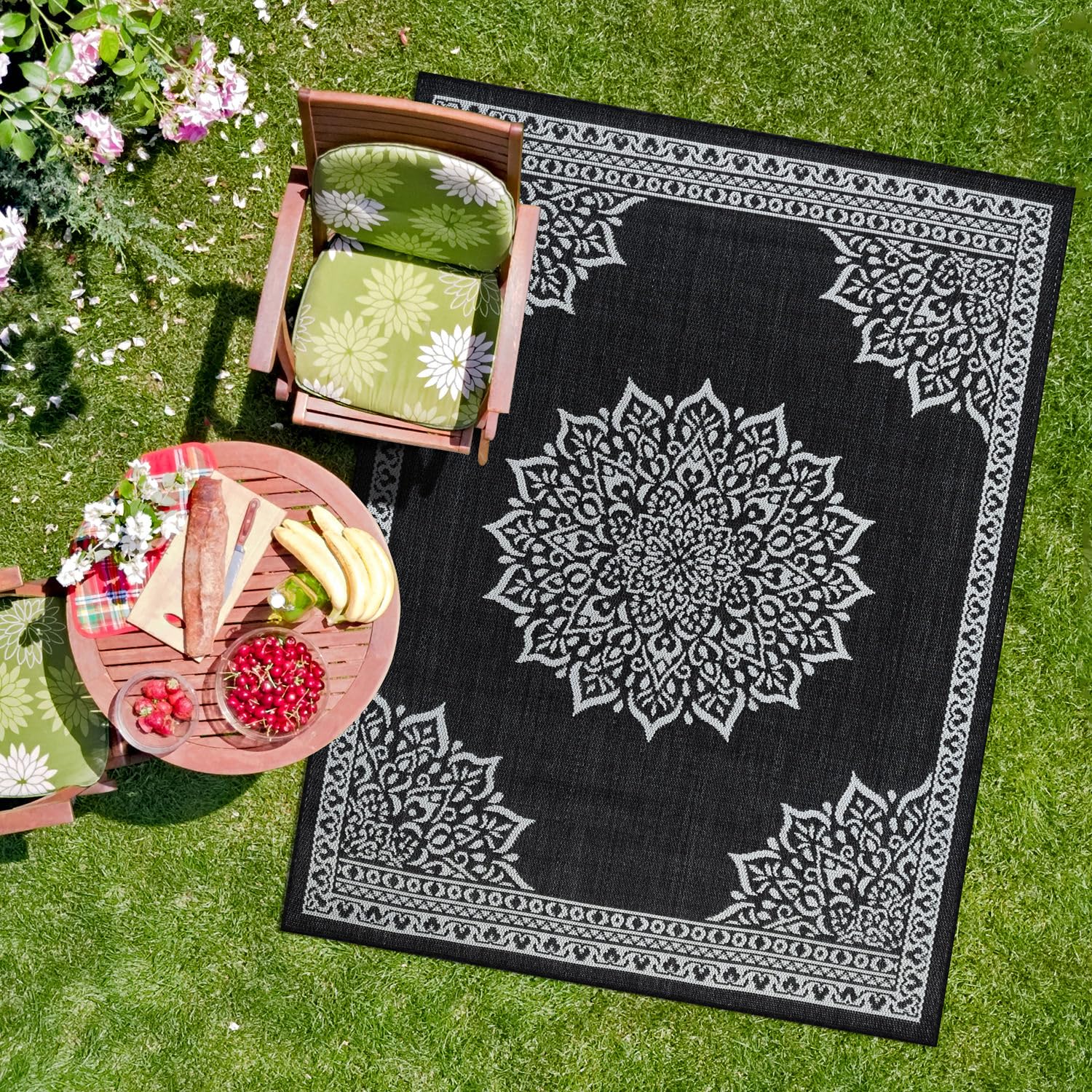 CAMILSON Outdoor Rug 6x9 Medallion Black on a patio
