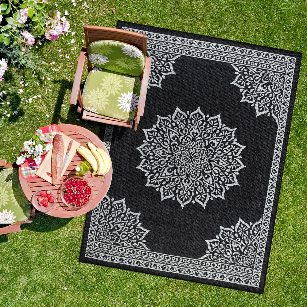 CAMILSON Outdoor Rug 6x9 Medallion Black on a patio