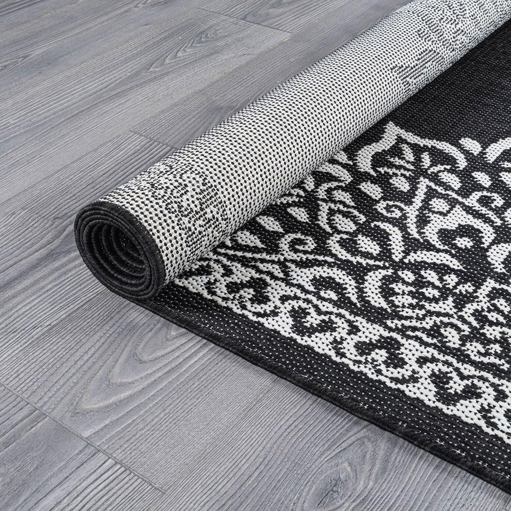 CAMILSON Outdoor Rug 6x9 Medallion Black rolled up
