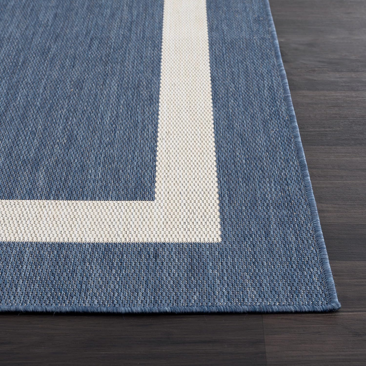 CAMILSON Outdoor Rug being washed with a hose