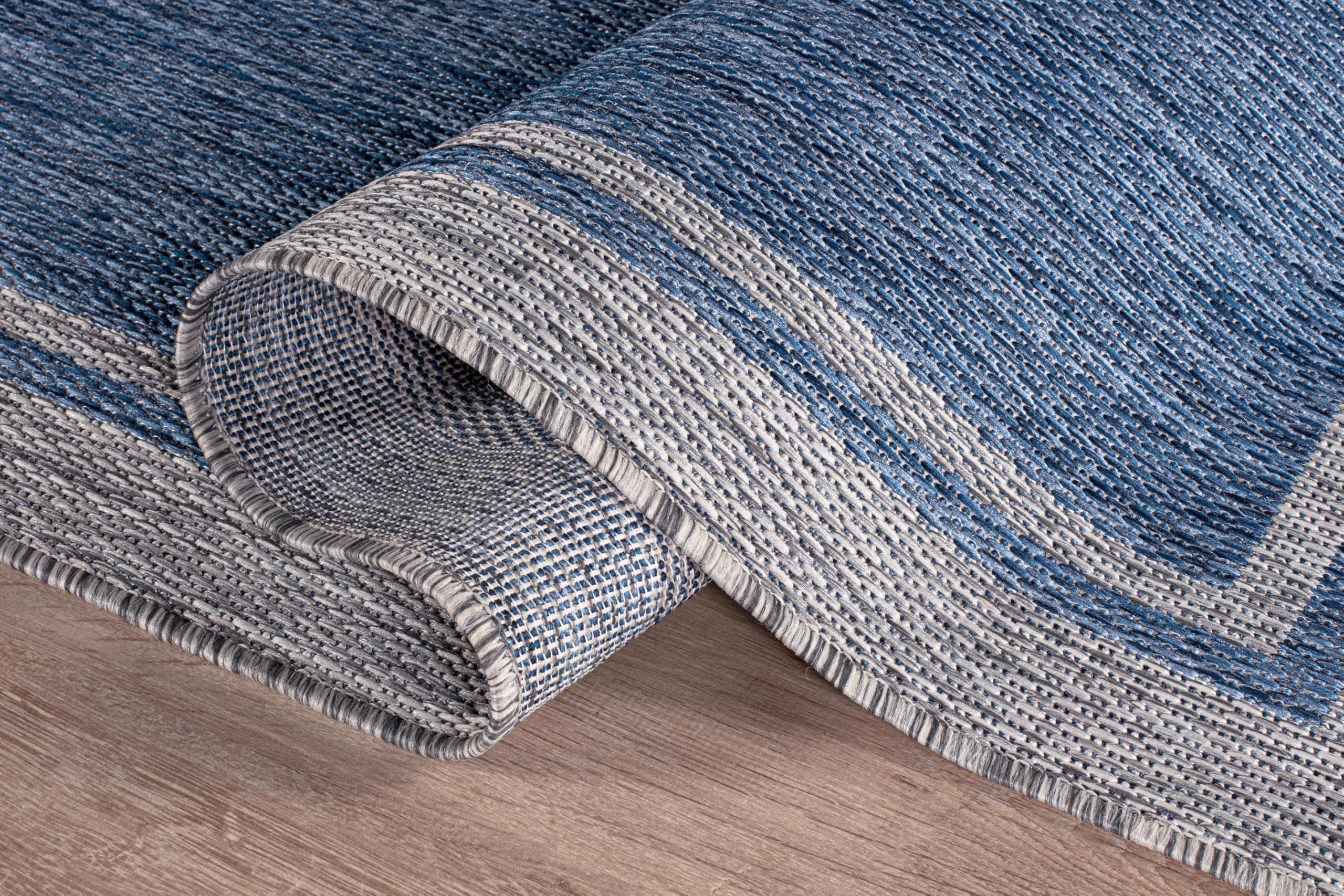 CAMILSON Outdoor Rug on a deck with furniture