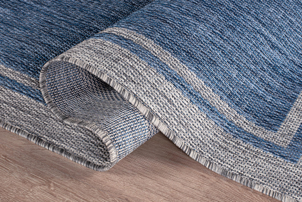 CAMILSON Outdoor Rug on a deck with furniture