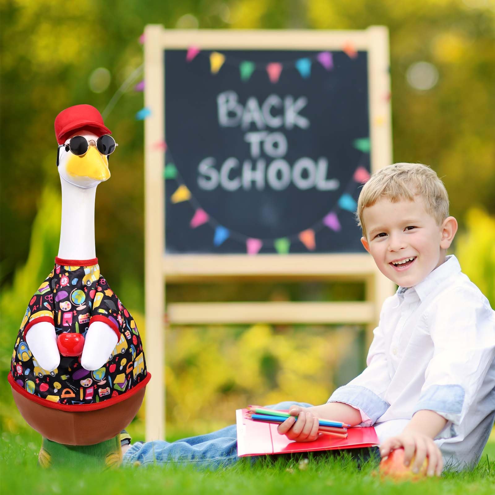 Cement goose statue dressed in playful school outfit