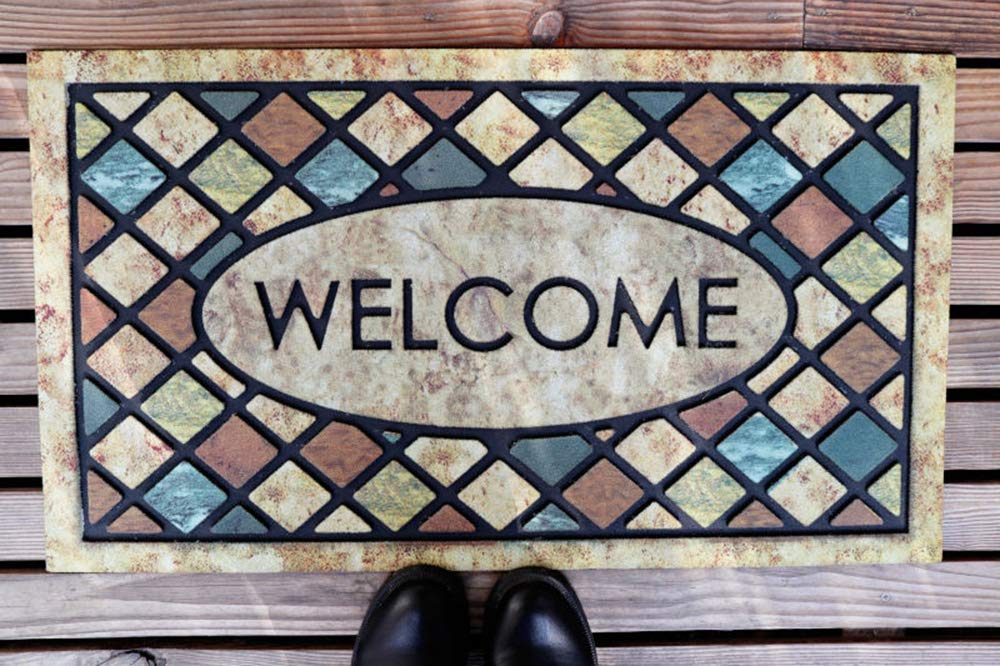 CHICHIC Blue Welcome Door Mat in a mudroom setting