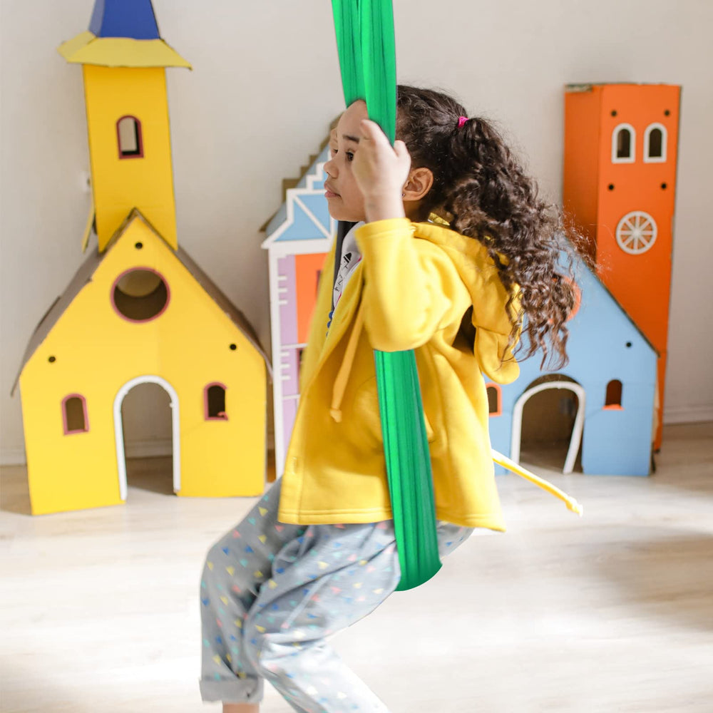 Chihee Sensory Swing hanging from a branch in a garden