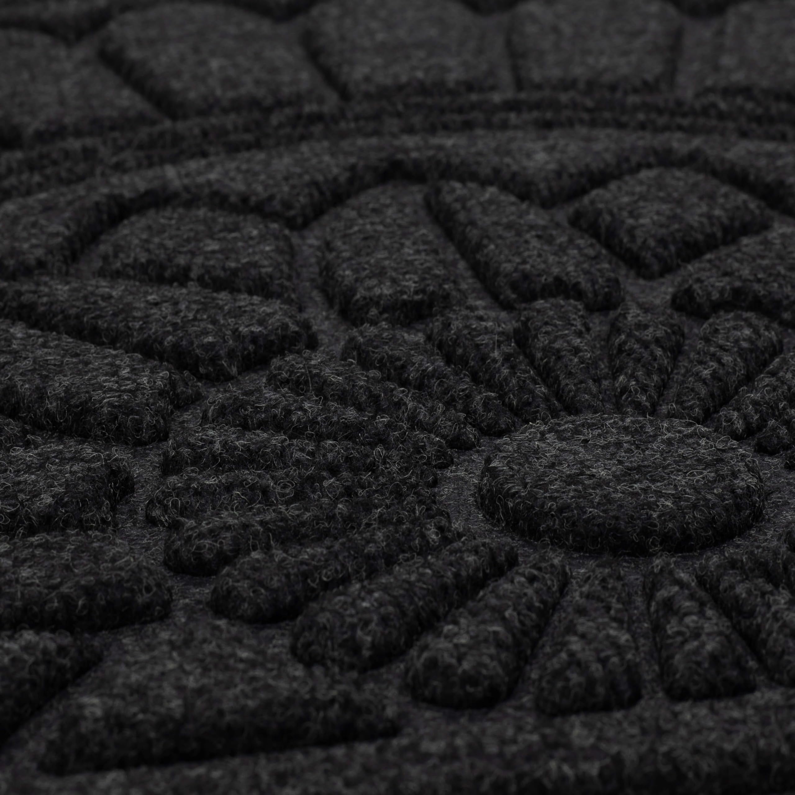 Cleaning the Mohawk Home doormat with a garden hose