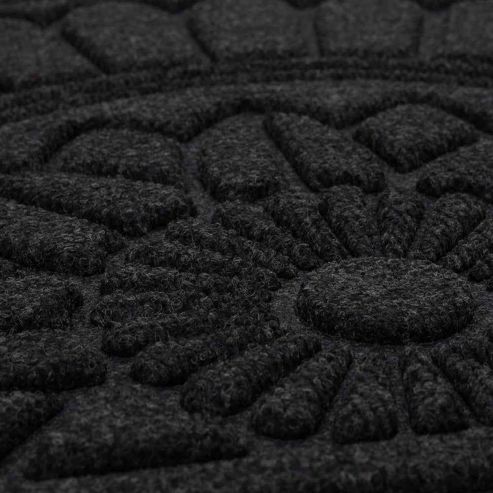 Cleaning the Mohawk Home doormat with a garden hose