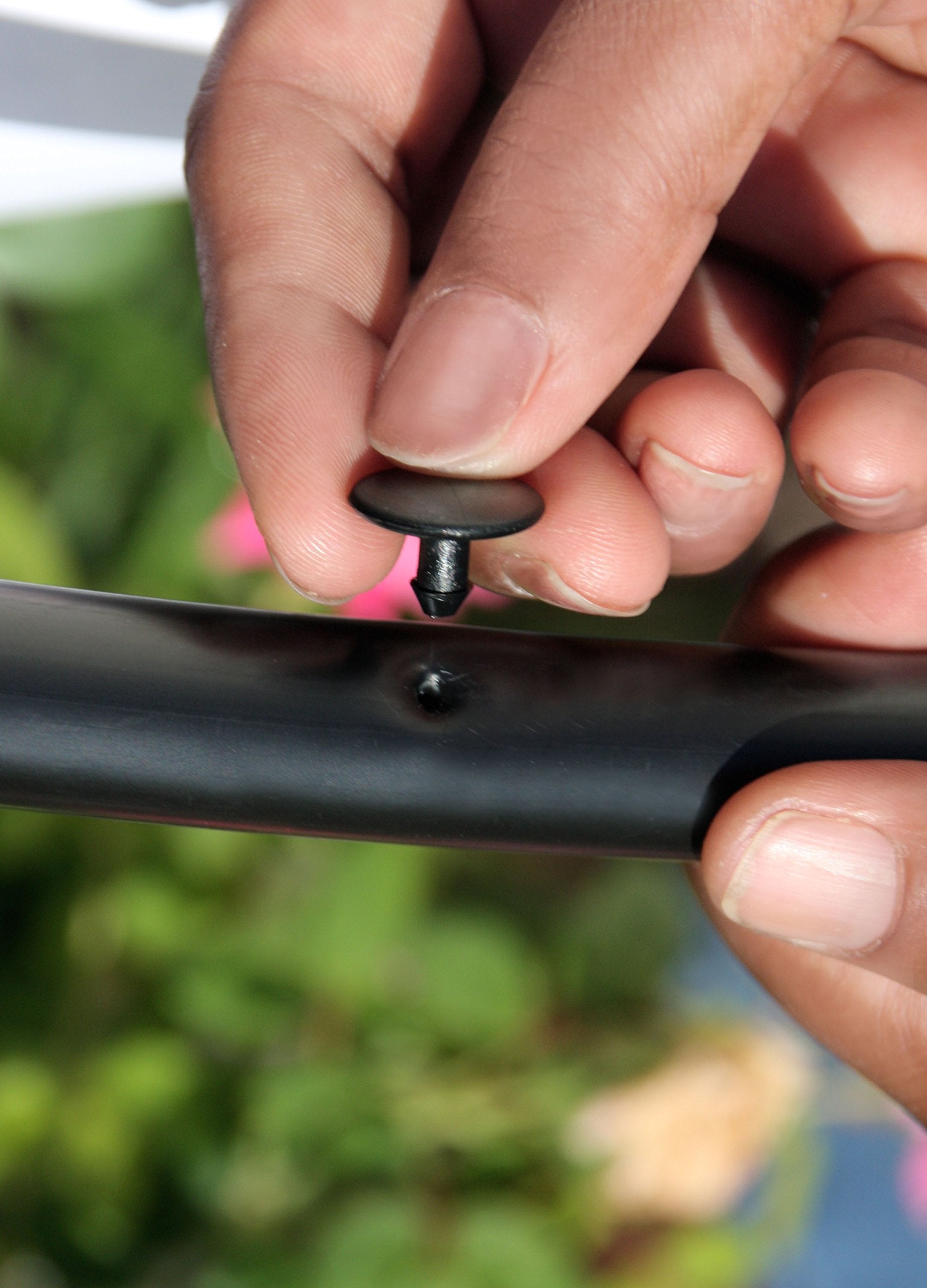 Close-up of a Mister Landscaper Goof Plug inserted in tubing