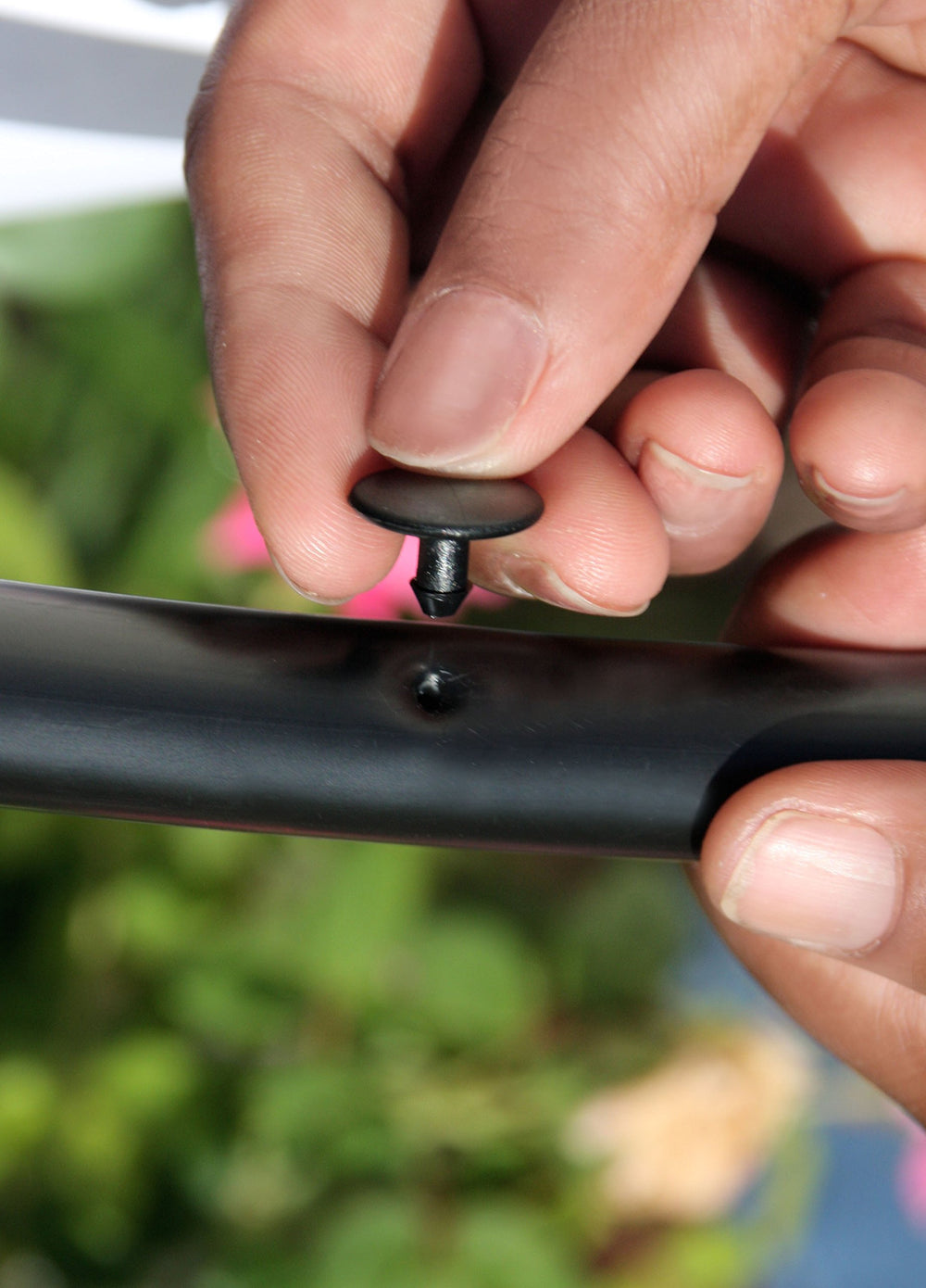Close-up of a Mister Landscaper Goof Plug inserted in tubing