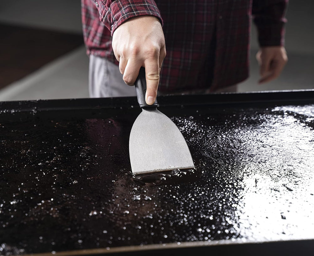 Close-up of BLACKSTONE stainless steel griddle scraper